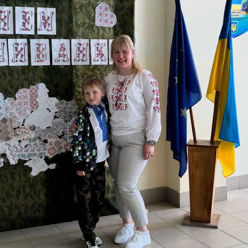 Photo of a young lady in a pink coat outside. 