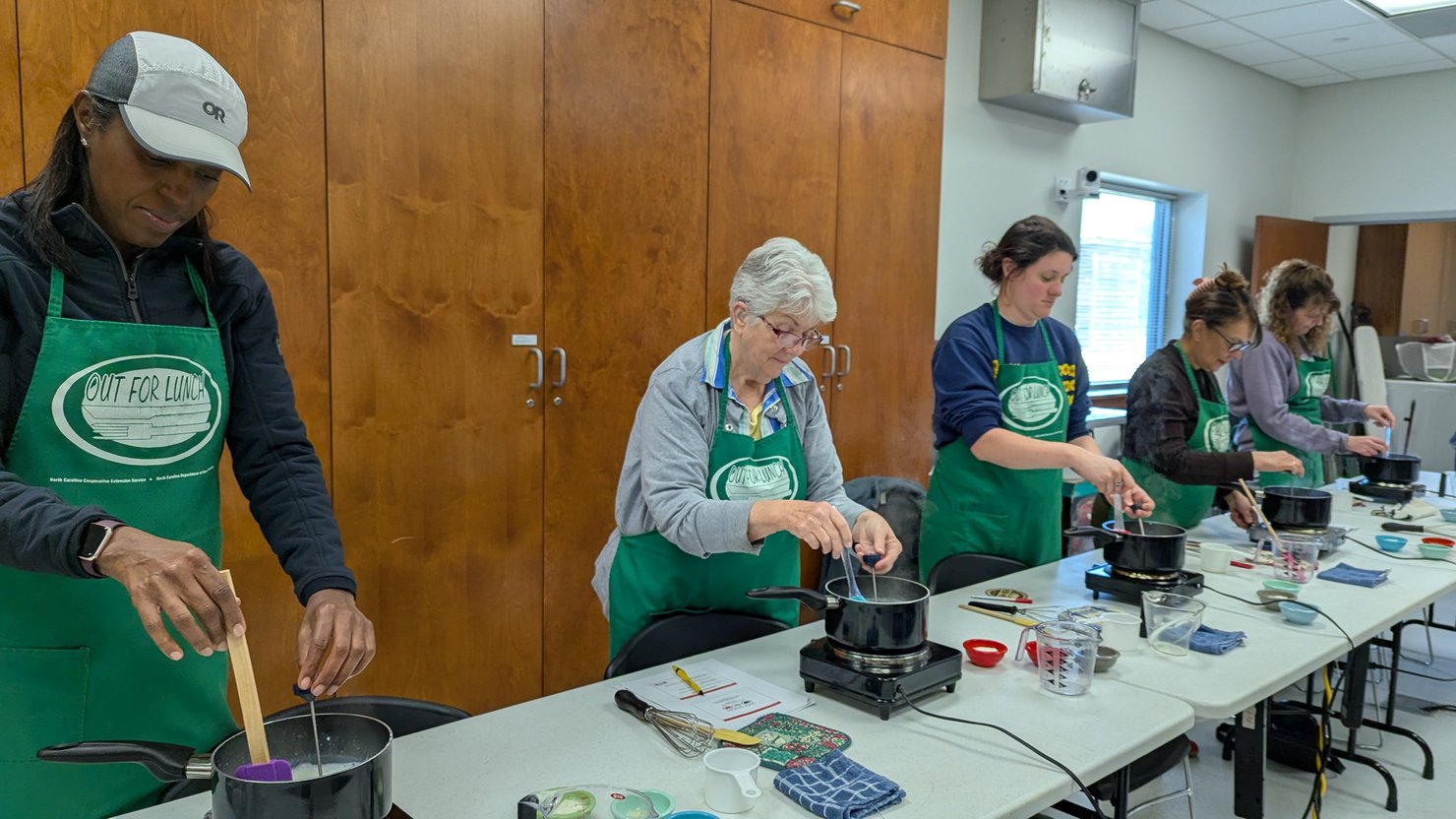 Participants in a fermentation class learning to make yogurt together.