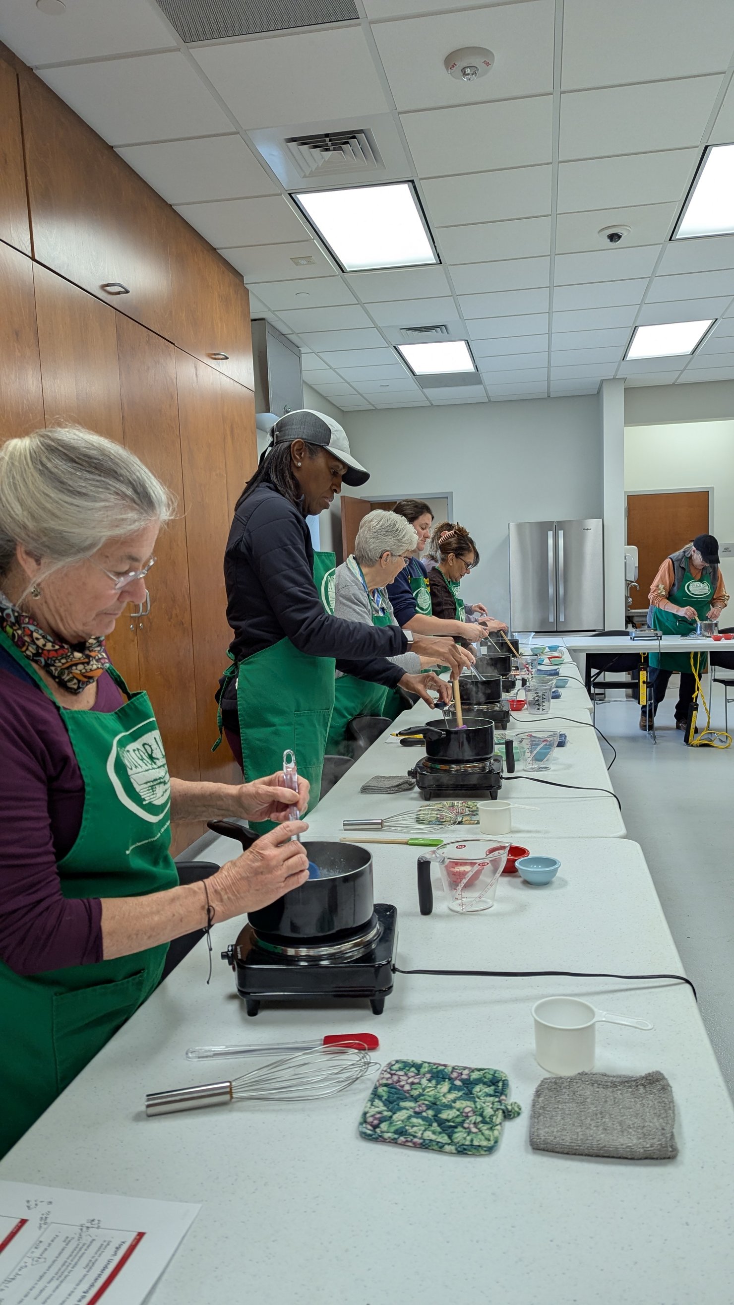 Participants in a fermentation class learning to make yogurt together.