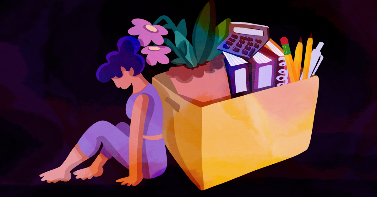 a woman sits with her back against moving boxes