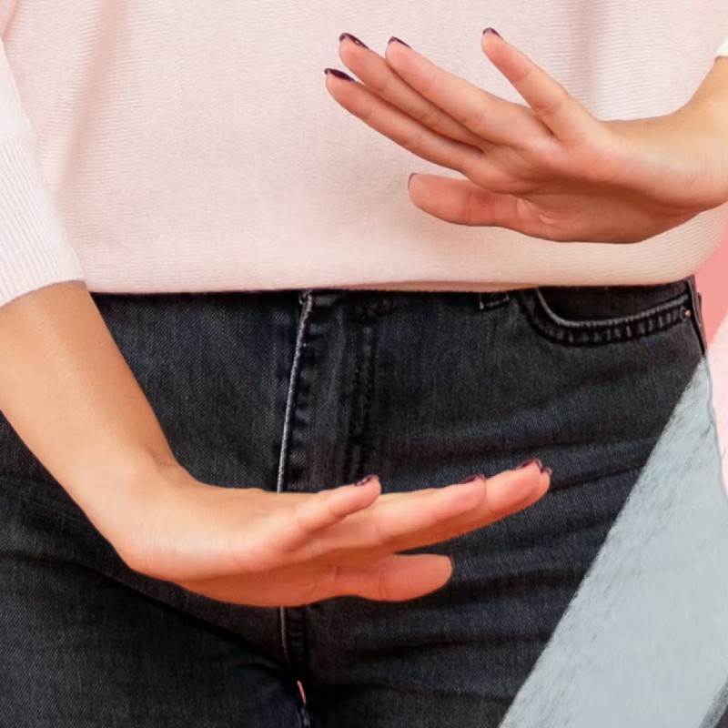 Image of a woman with her hands horizontal, indicating space between her lower stomach and her pelvis