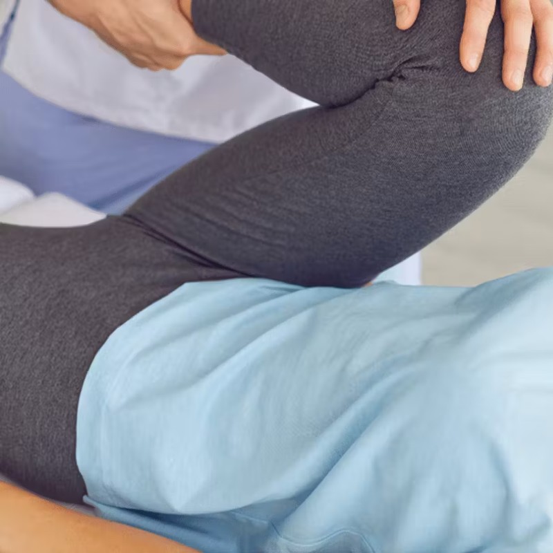 Image of someone stretching their pelvis on the floow