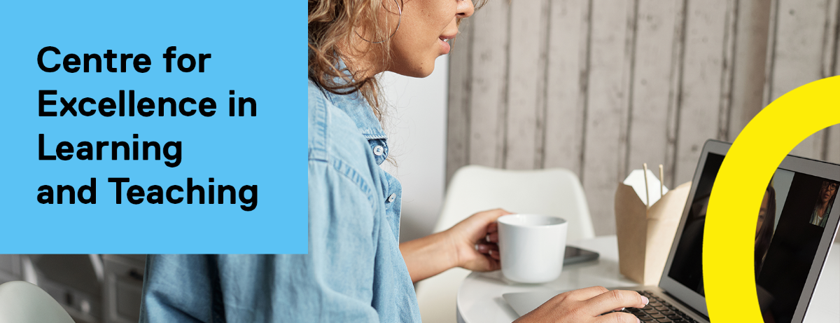 A person video chats on a laptop while holding a coffee mug.