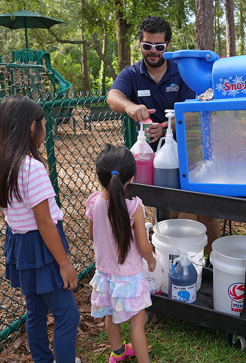 Parks staff preparing a snowcone at Parks are Poppin Event