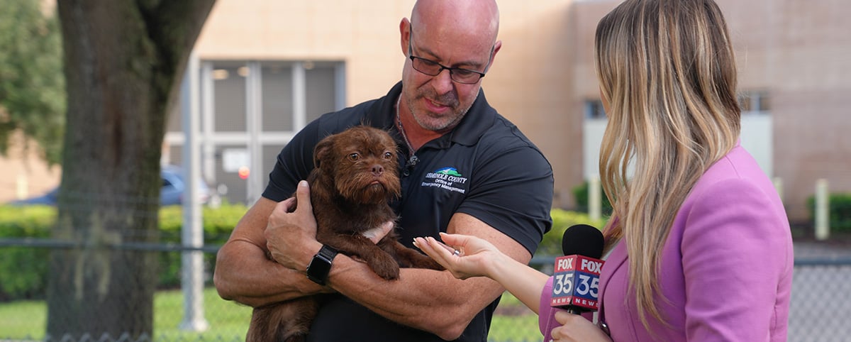 News interviews Alan Harris, who is holding a dog