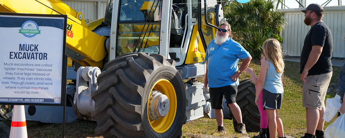 county employee standing next to equipment having a conversation with residents county employee standing next to equipment having a conversation with residents