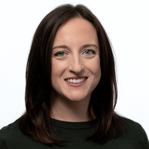 Professional portrait of Windy Ross in
a denim jacket, black shirt, and hoop earrings
