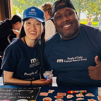 Photo of Jennifer Duong and Shay Marlowe posing for a photo at an ourdoor event in Minnesota State branded gear