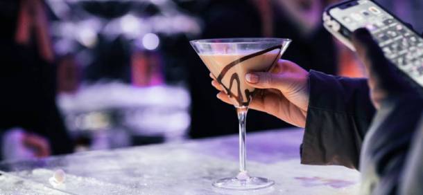 hand holding chocolate martini at ice bar