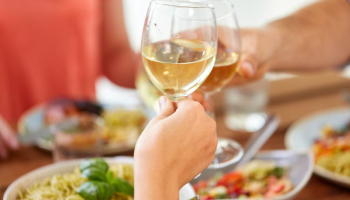 cheers with wine glasses over food cheers with wine glasses over food