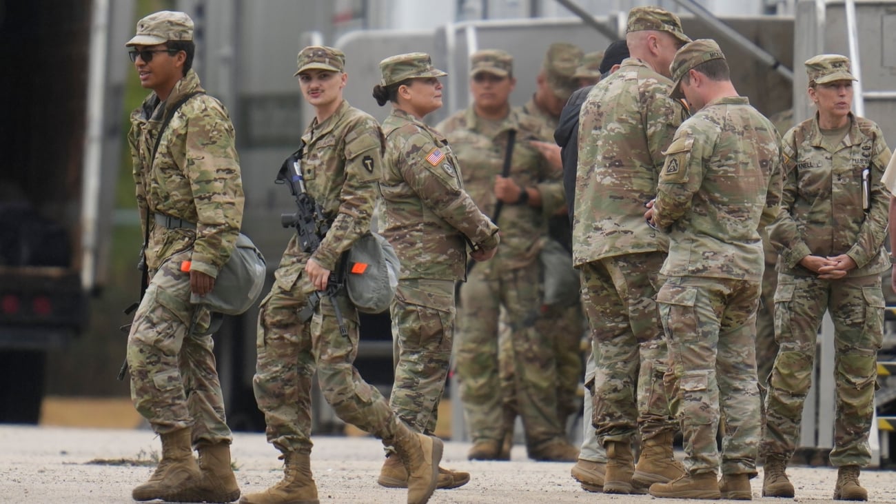 Military personnel in uniform, with the Texas National Guard patch on, are seen at the U.S. Army Reserve Center, Tuesday, Oct. 7, 2025, in Elwood, Ill., a suburb of Chicago. (AP Photo / Erin Hooley)