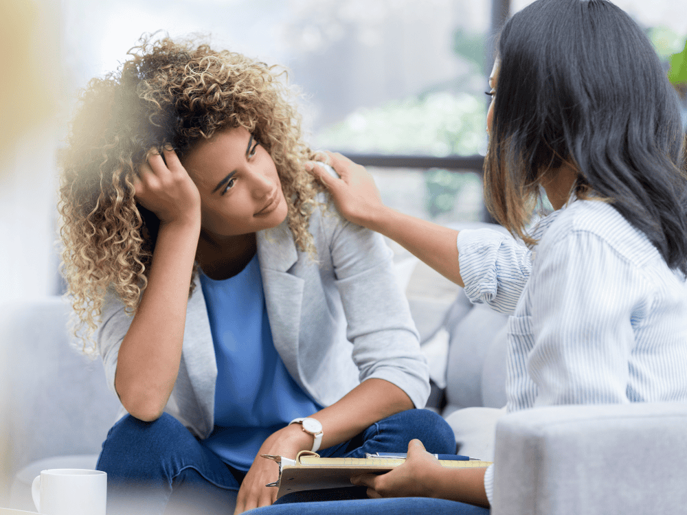 Photo of woman comforting another woman