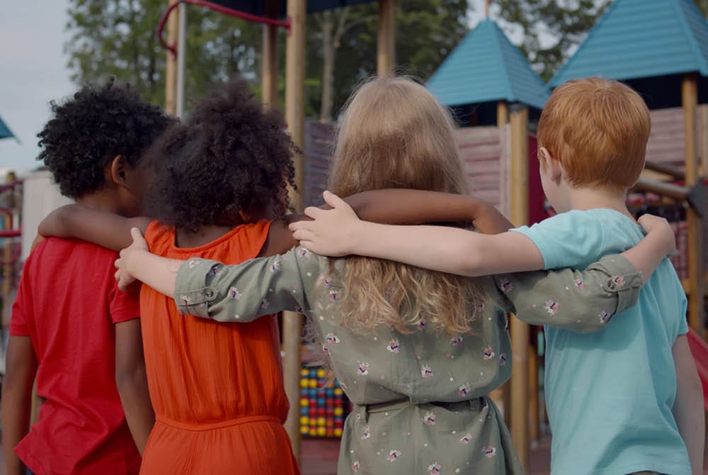 Children with arms around each other's backs