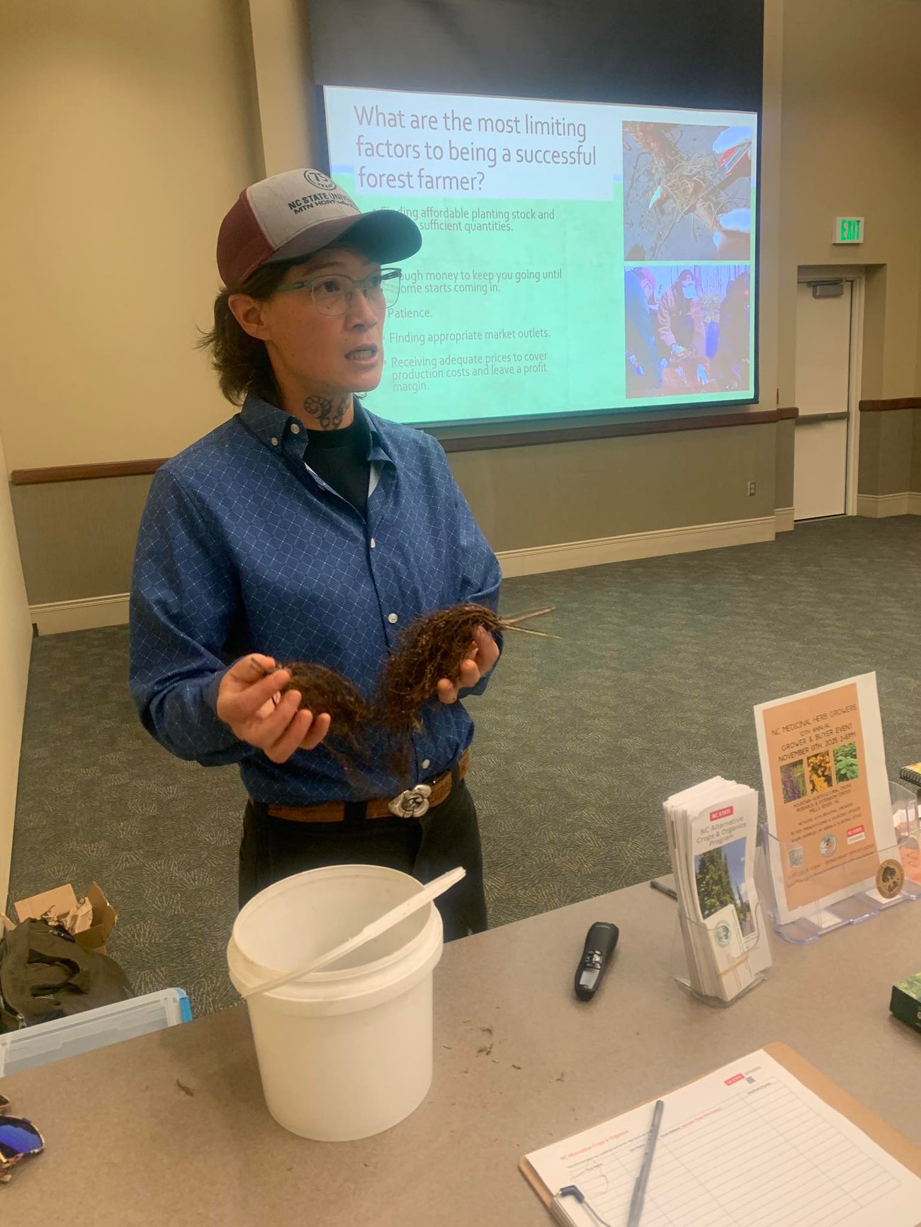 Mary holding roots and presenting on forest farming