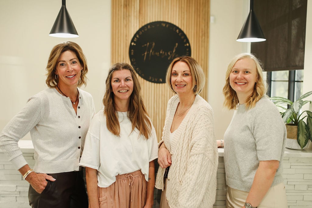 4 women standing at reception desk