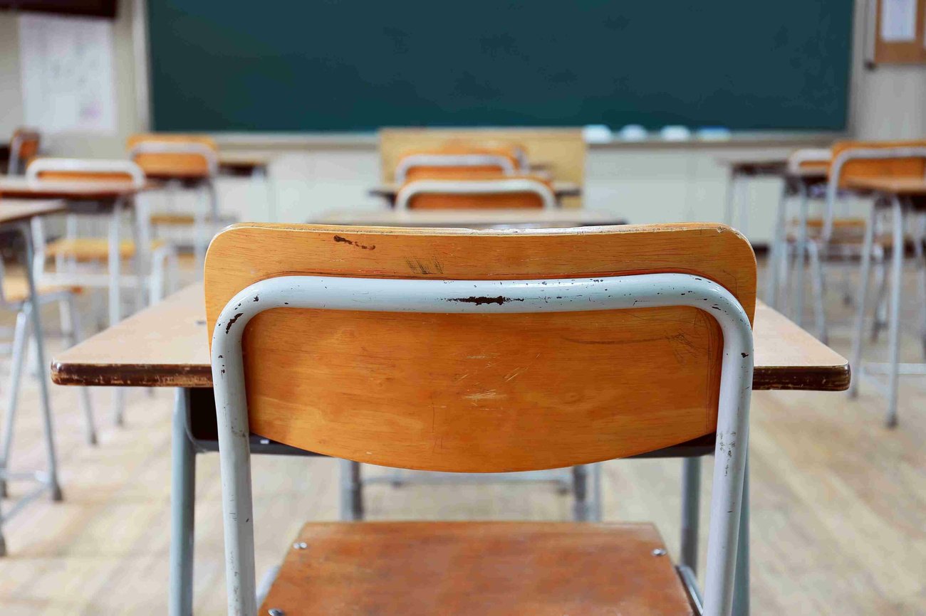 Photo of classroom desks facing the blackboard.