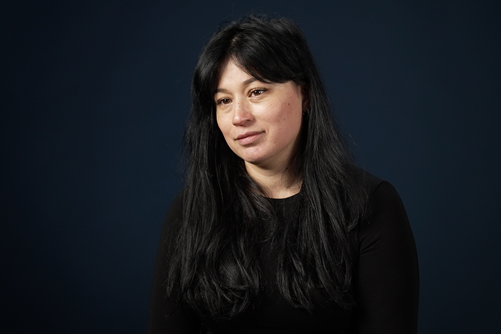 Image of Kamola Salimova, a person with long dark hour wairing a sweater. 