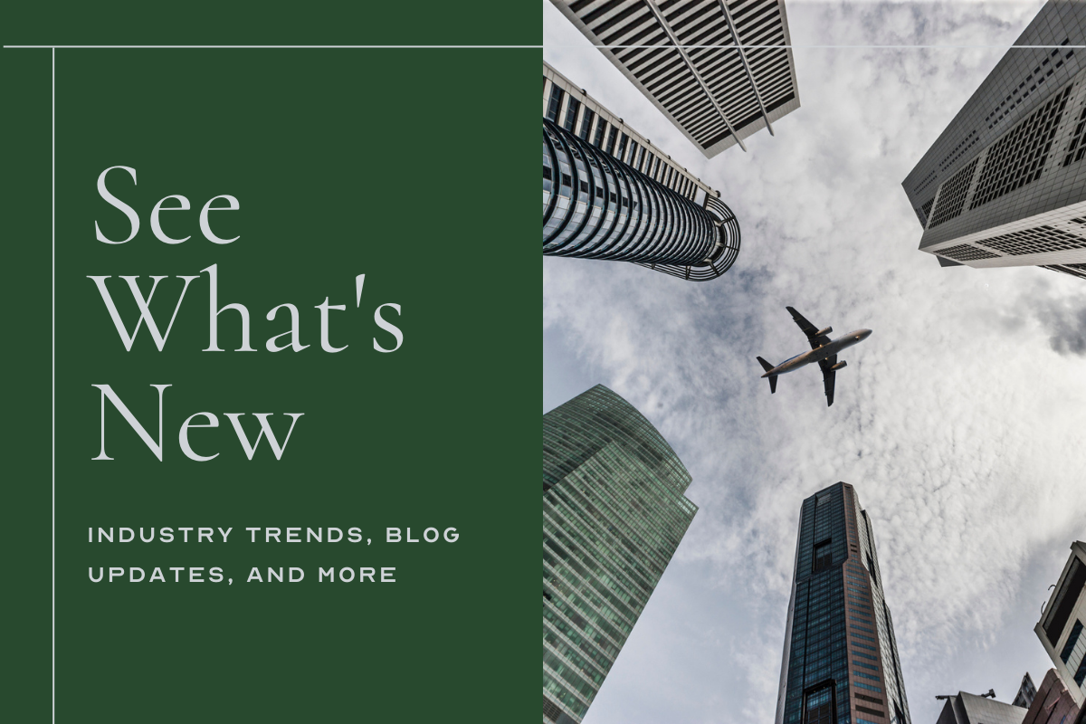 See What's New Industry Trends, Blog Updates, And More image: airplane flying directly overhead over skyscrapers