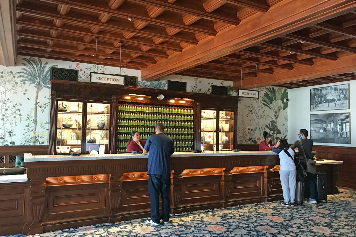 people in an upscale hotel lobby checking in.