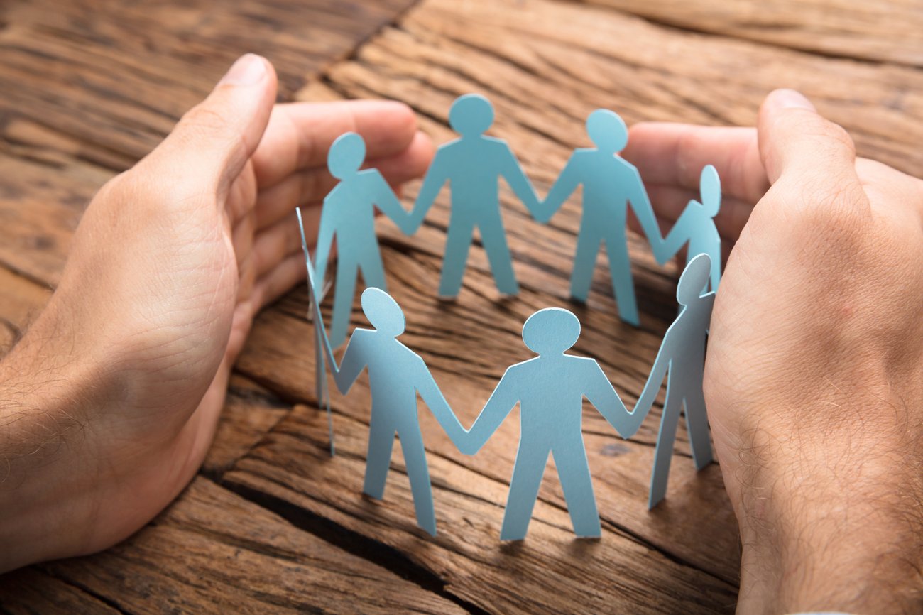  hands surround and "protect" cut out of people