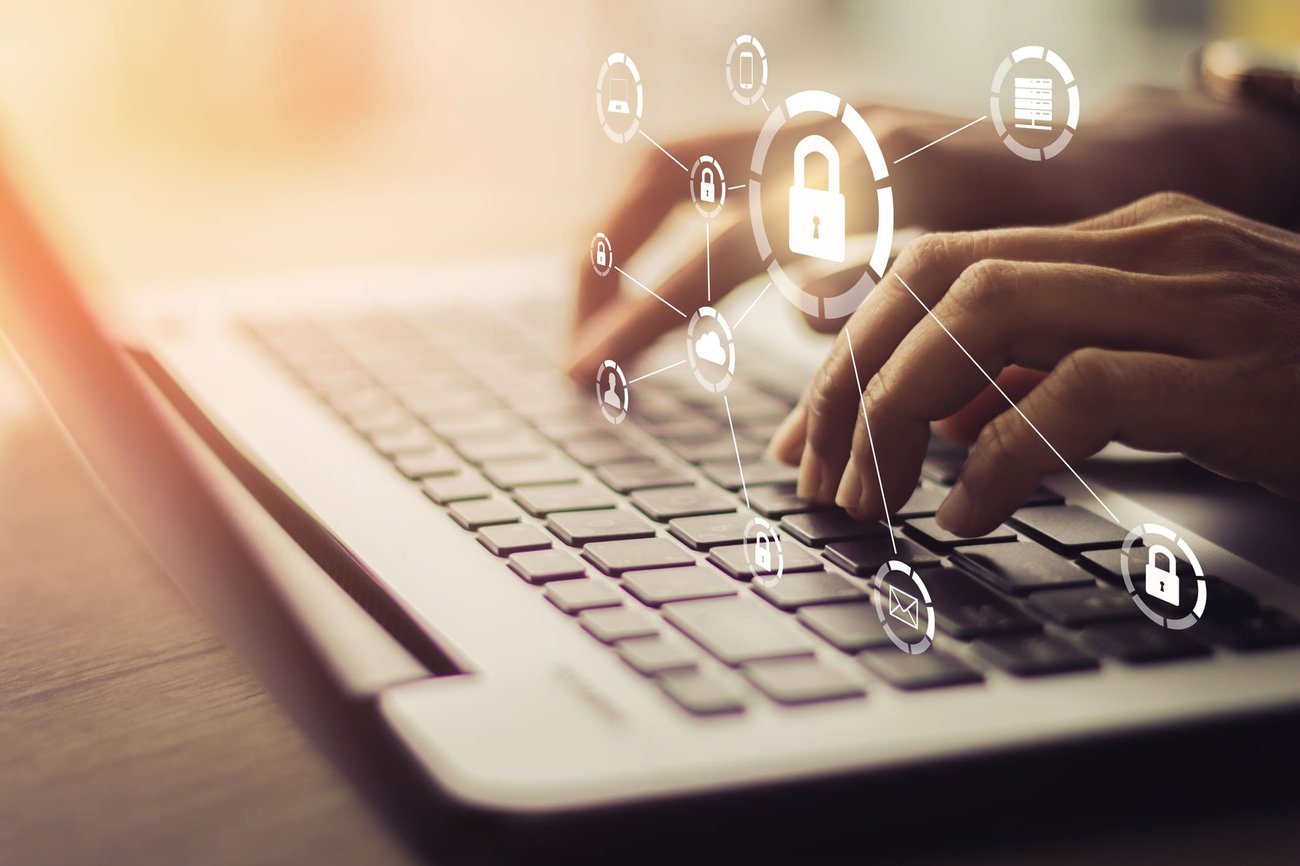 person typing on computer, security overlay