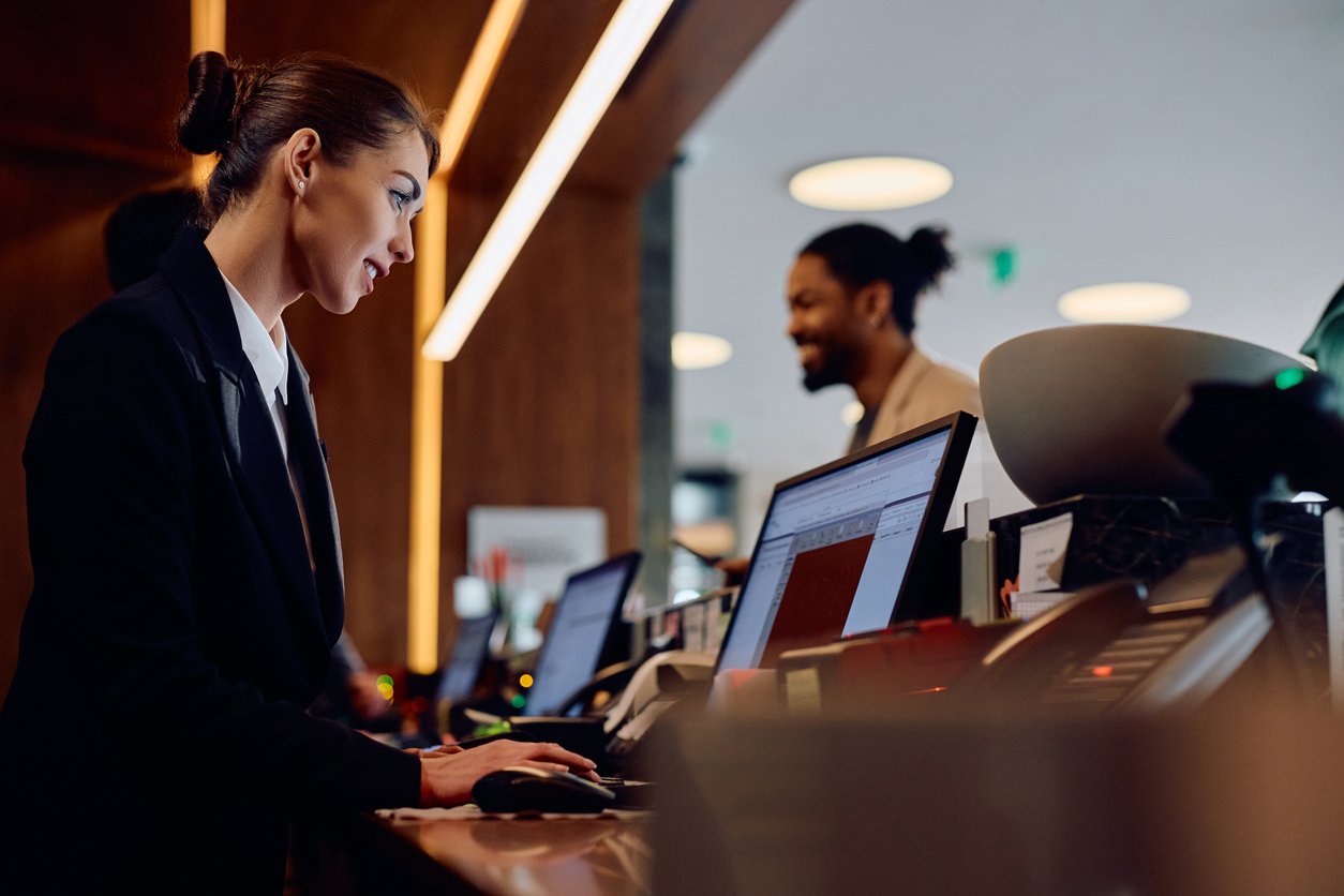 Smiling hotel front desk employee