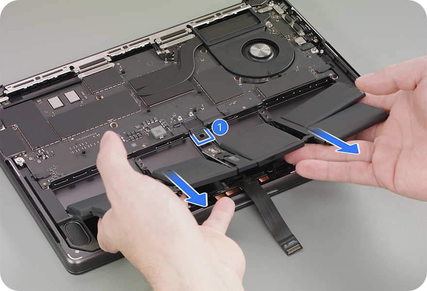 Image: Apple repair guide image demonstrating how to slide the M5 MBP's battery assembly out from under the metal battery management unit (BMU).