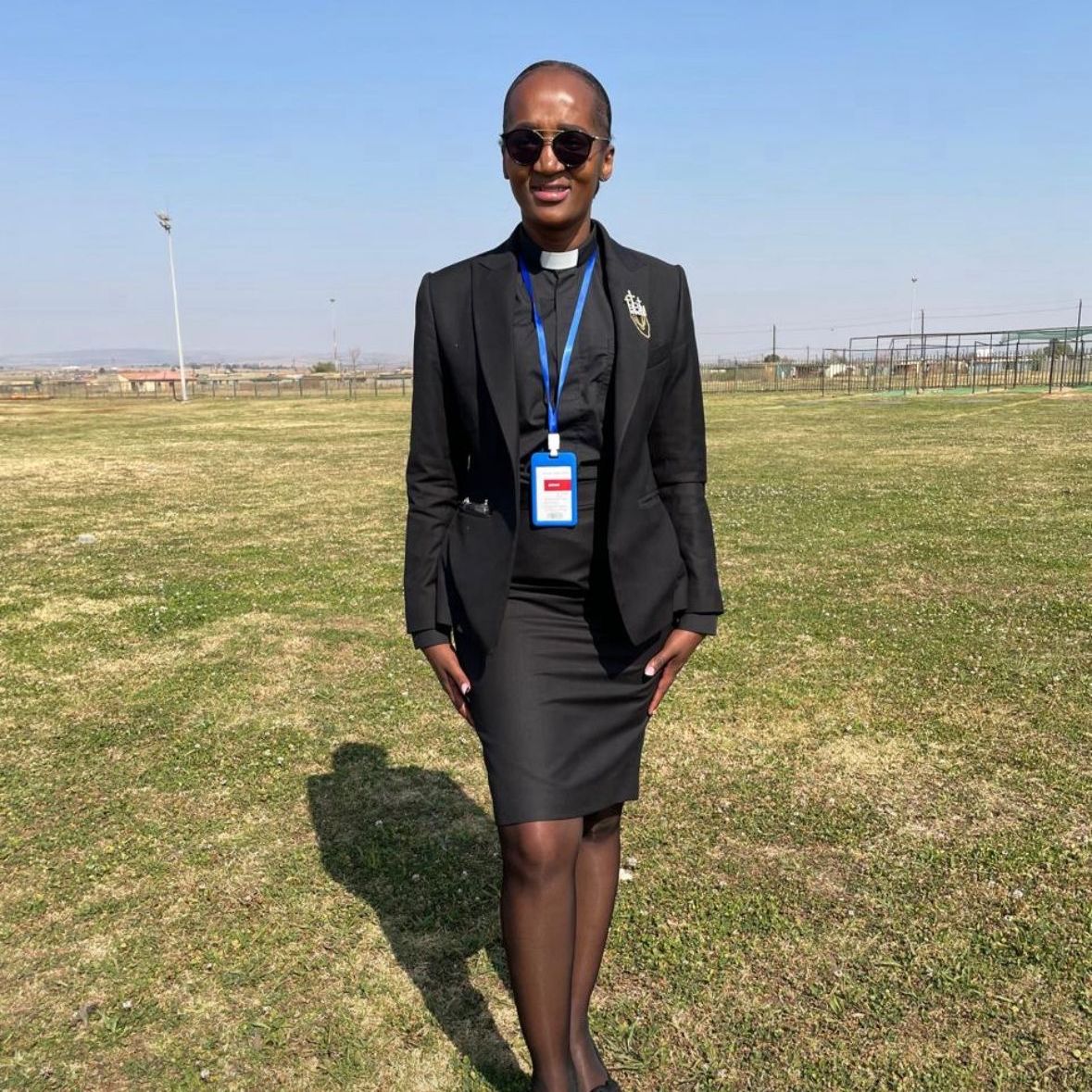 Image of a lady in smiling with sunglasses on. 