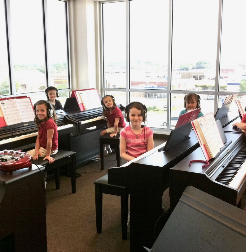 group piano students learning a new song