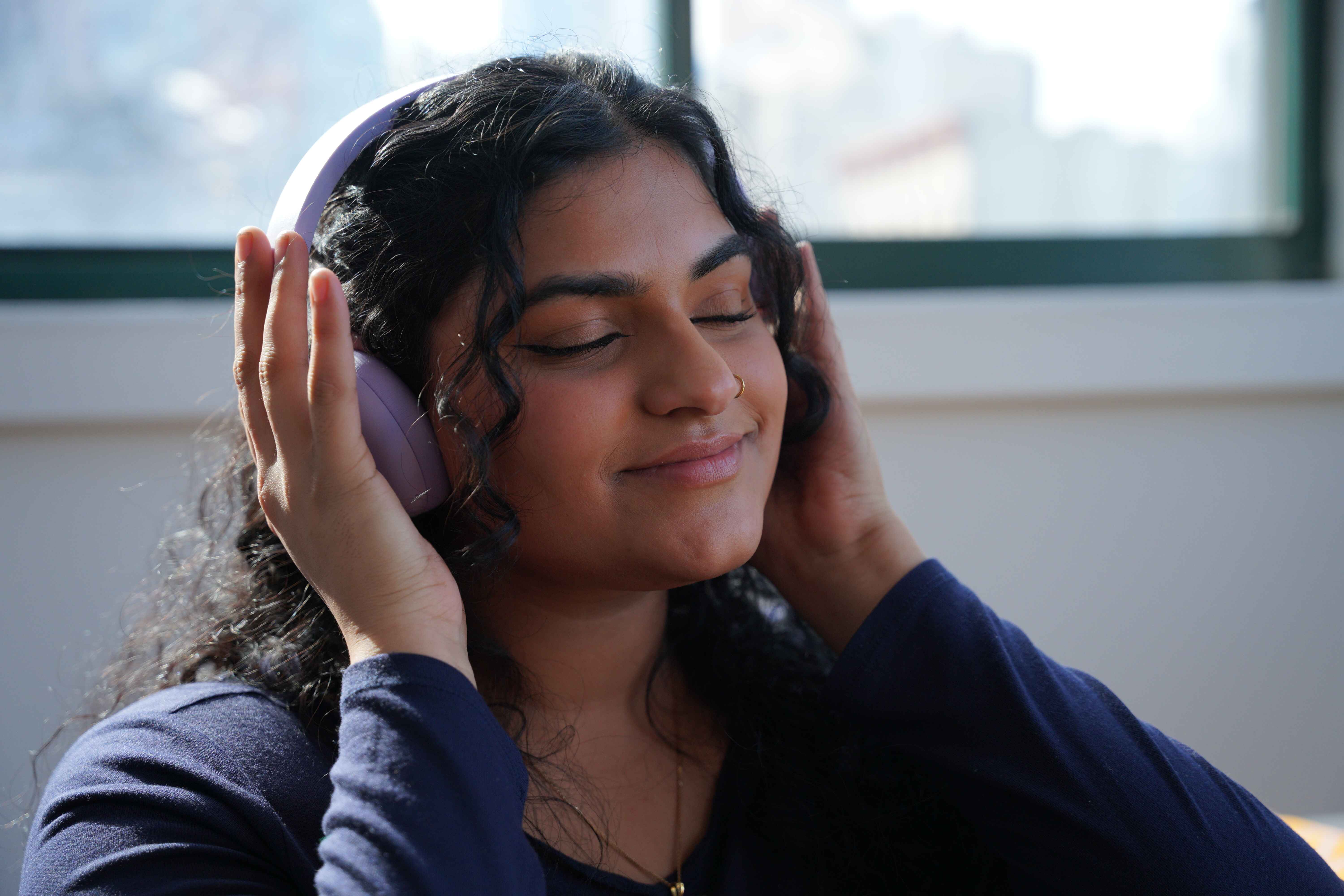 patient smiling and adjusting headphones after therapy session