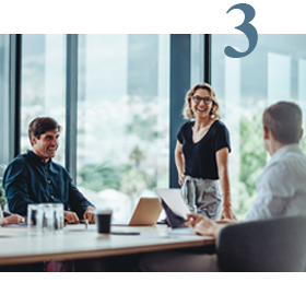 people smiling in a work meeting