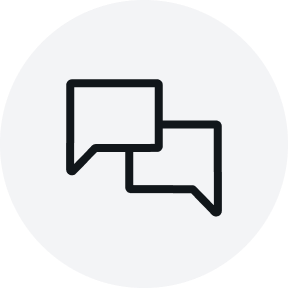 Light grey circular icon showing two overlapping black speech bubbles, centered on a solid background.