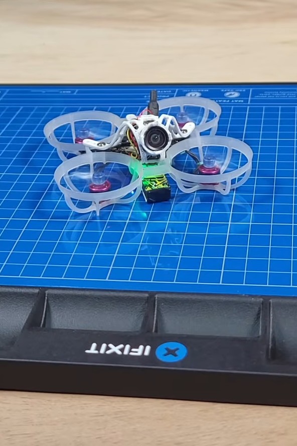 Nick Random's 65mm Tiny Whoop drone on an iFixit mat