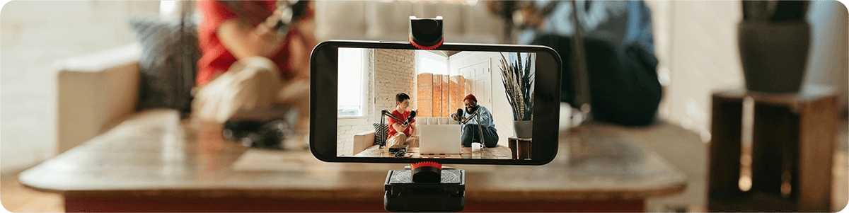 An image of two creators being filmed on an iPhone'